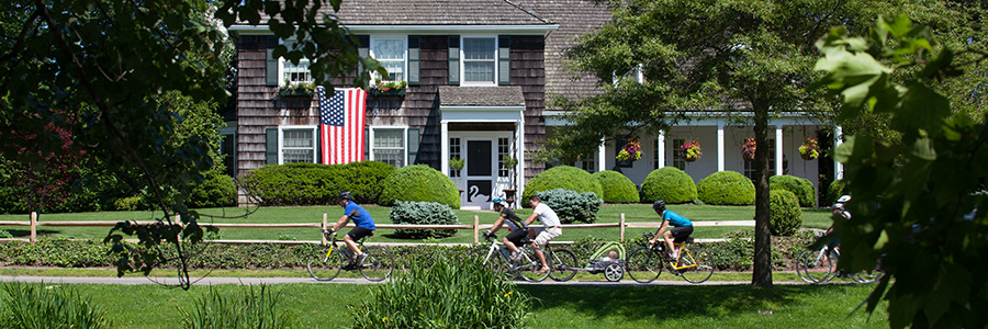 image of cyclists riding in front of a historic building